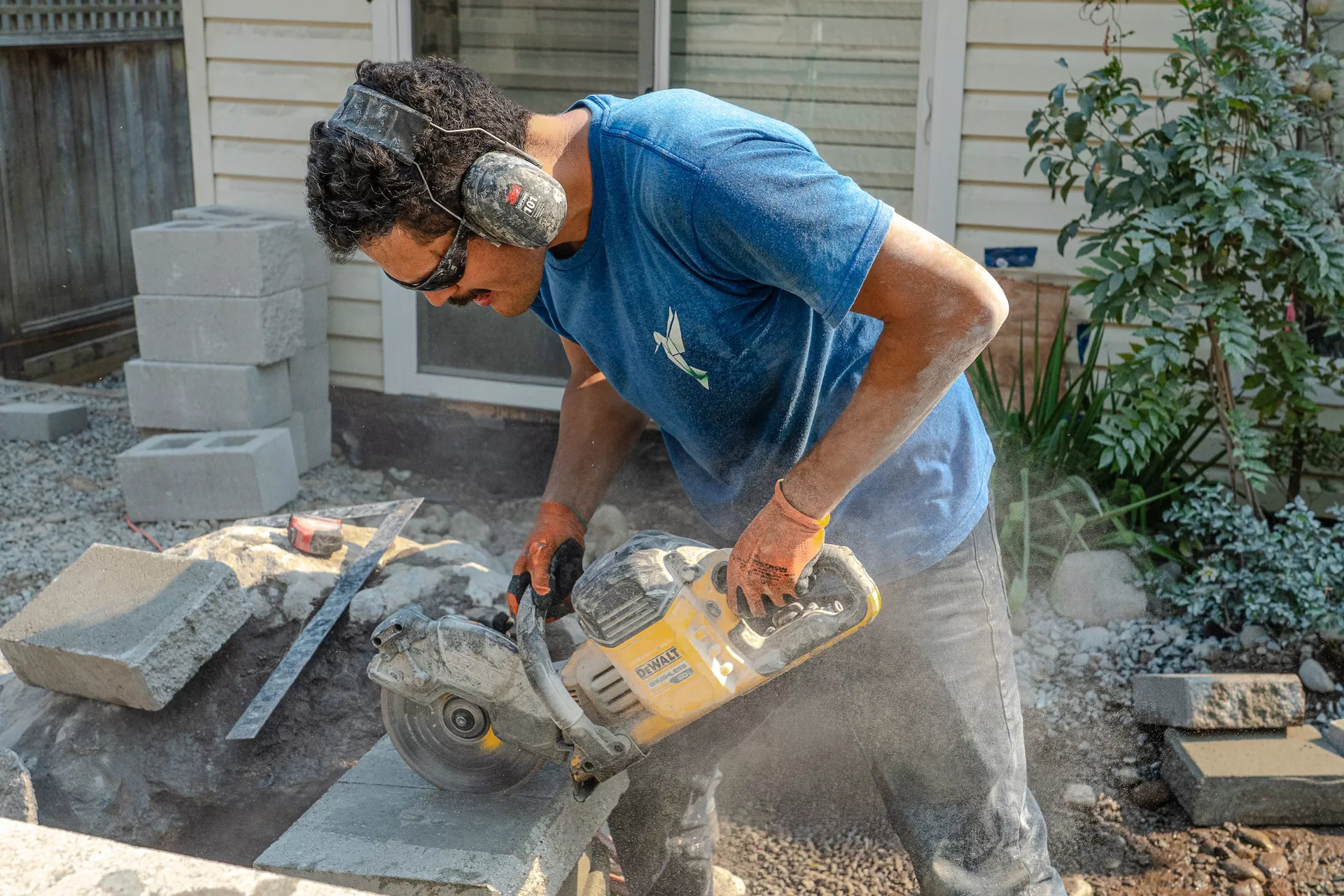 construction working, doing hardscaping work for a retaining wall. in vancouver